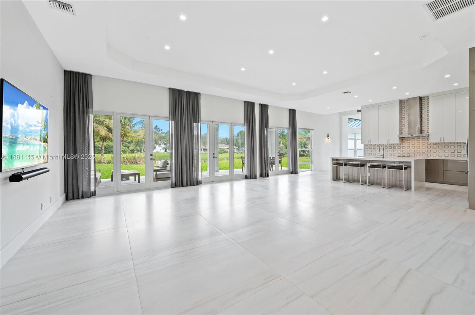 2400 Southwest 112th Avenue Davie, FL 33325 - Photo 13 of 61 a view of an empty room with wooden floor and windows