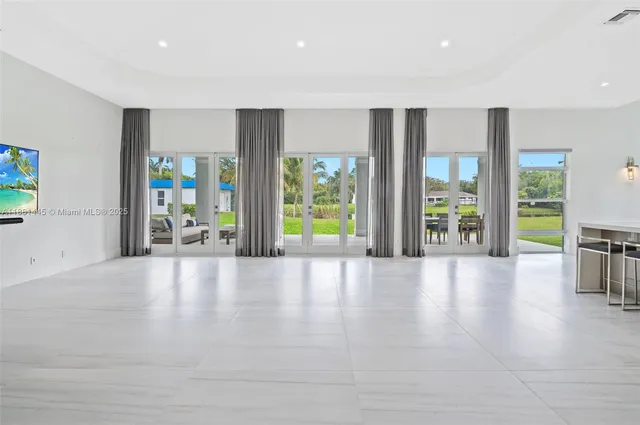 a large kitchen with a table and chairs in it