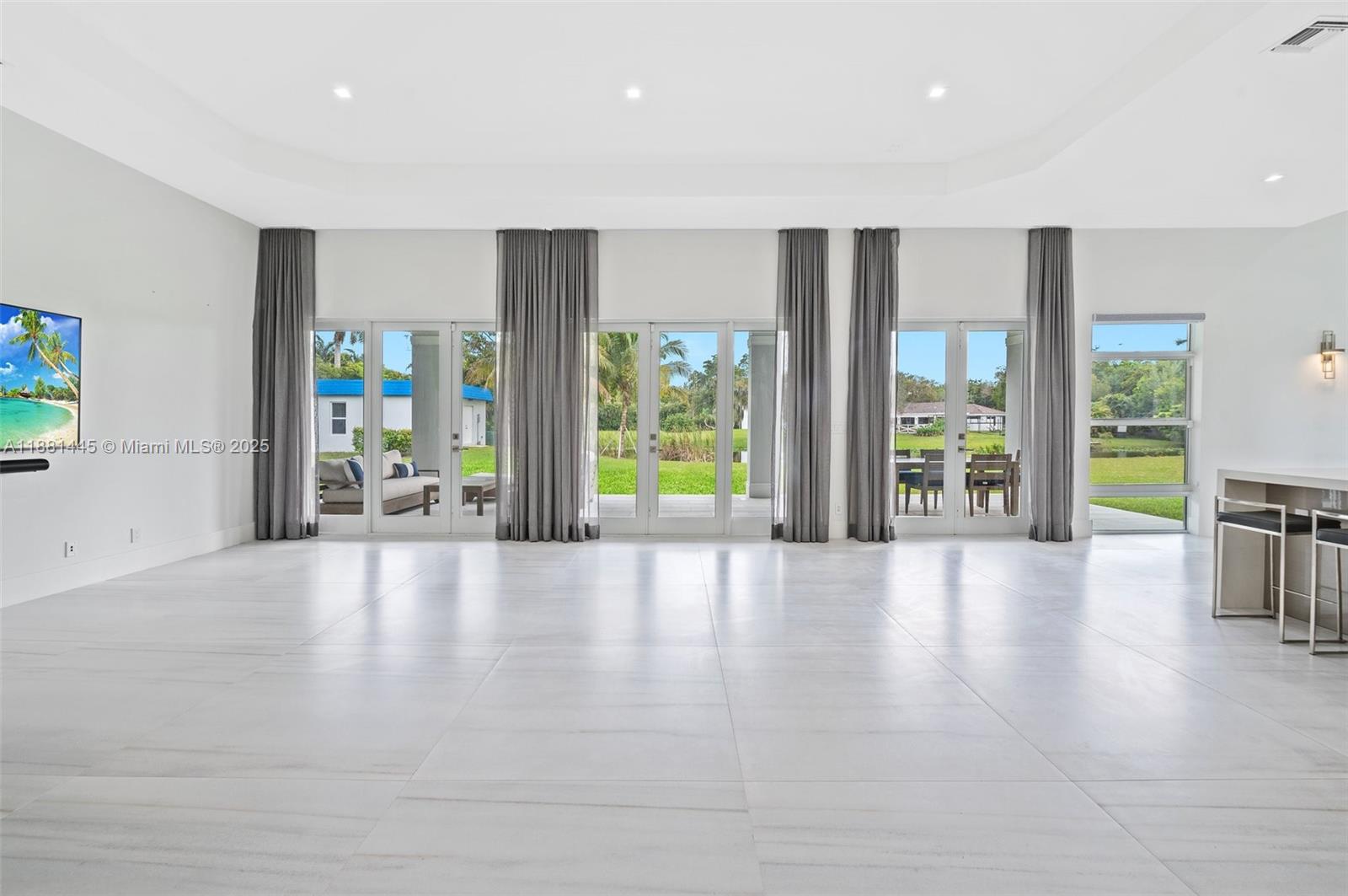 2400 Southwest 112th Avenue Davie, FL 33325 - Photo 14 of 61 a view of an empty room with wooden floor and a window