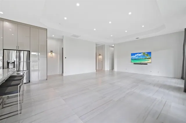 a kitchen with stainless steel appliances granite countertop a stove a sink a refrigerator and a microwave