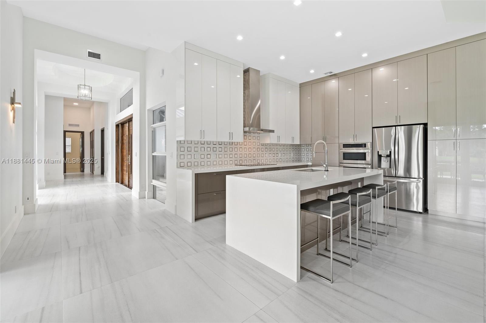 2400 Southwest 112th Avenue Davie, FL 33325 - Photo 16 of 61 a large kitchen with a table and chairs in it