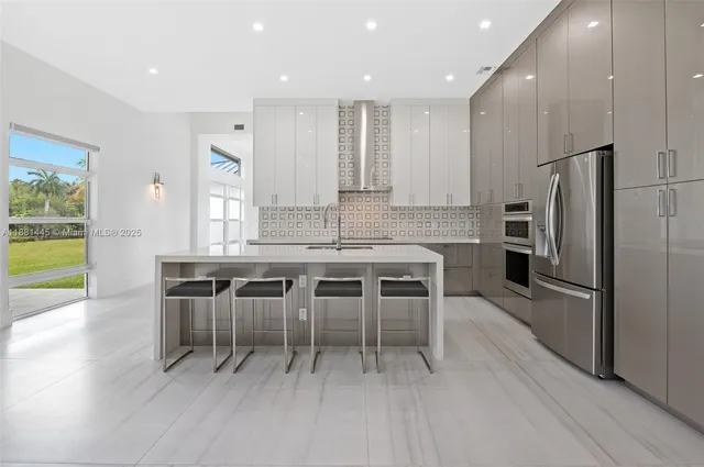 a kitchen with stainless steel appliances granite countertop a sink and cabinets