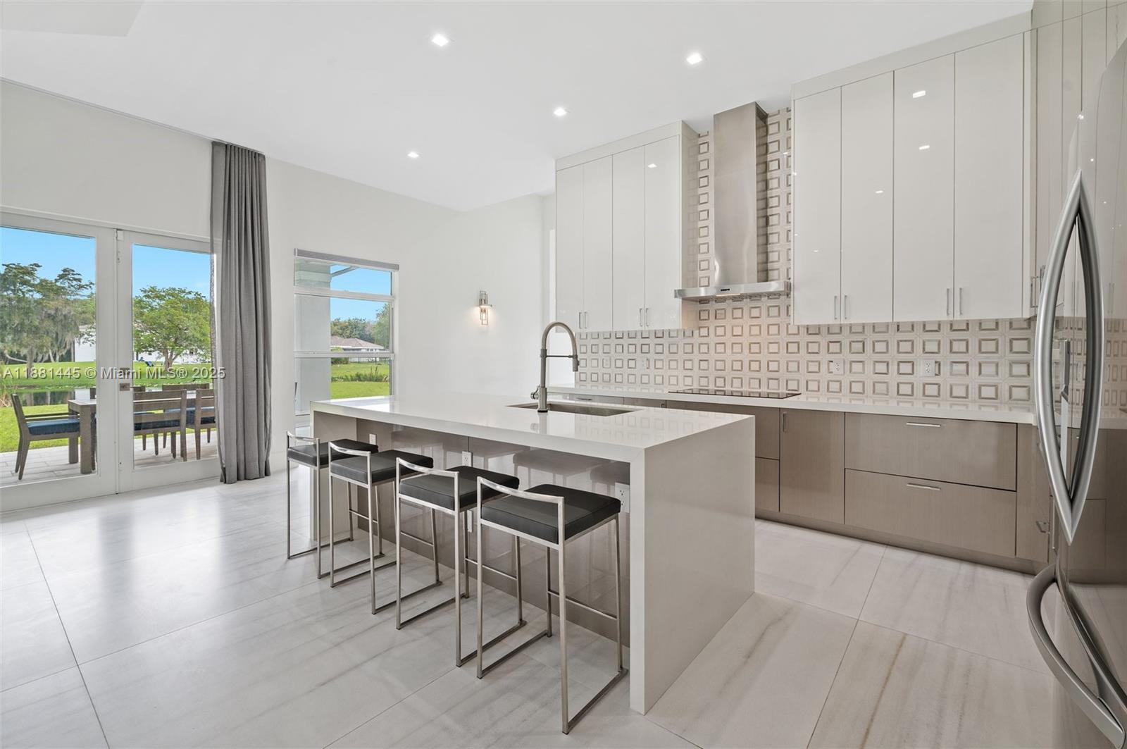 2400 Southwest 112th Avenue Davie, FL 33325 - Photo 19 of 61 a kitchen with stainless steel appliances granite countertop a sink and cabinets