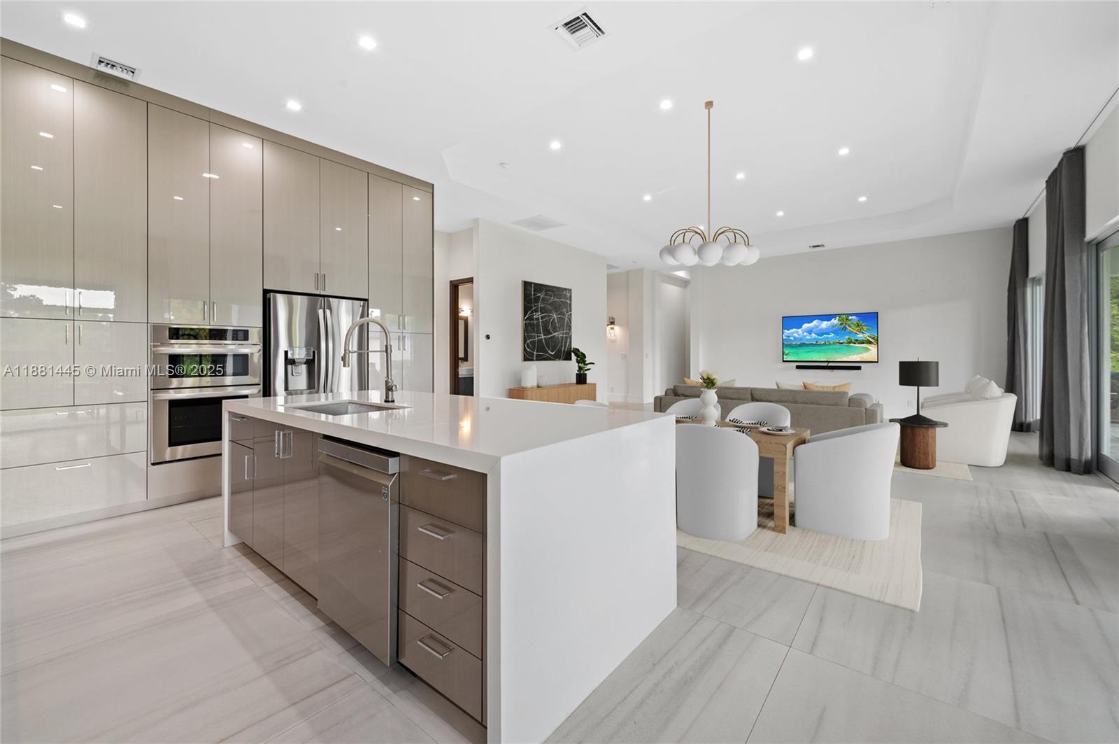 2400 Southwest 112th Avenue Davie, FL 33325 - Photo 20 of 61 a large kitchen with kitchen island white cabinets and stainless steel appliances