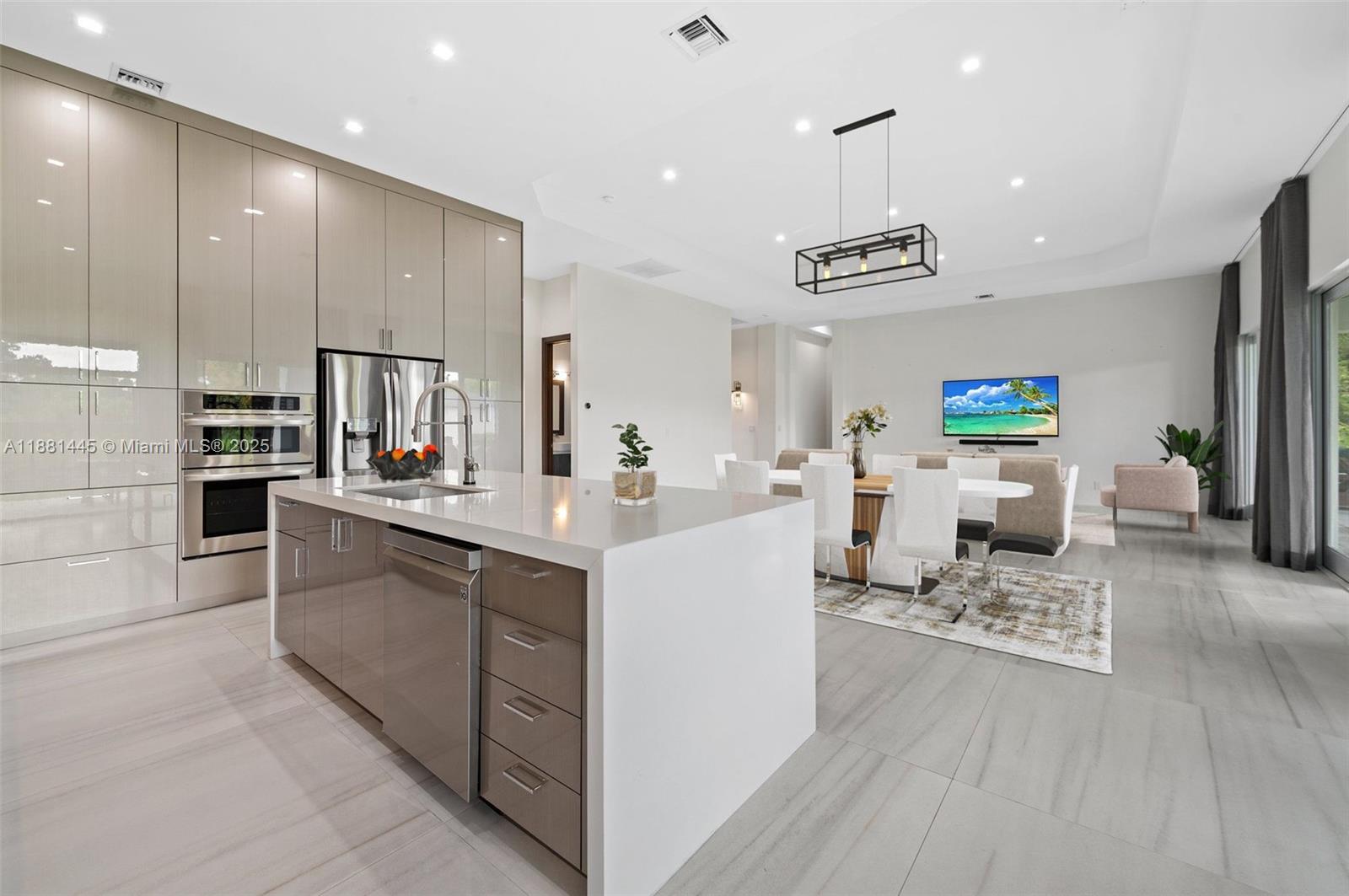 2400 Southwest 112th Avenue Davie, FL 33325 - Photo 21 of 61 a kitchen with stainless steel appliances kitchen island sink refrigerator and cabinets