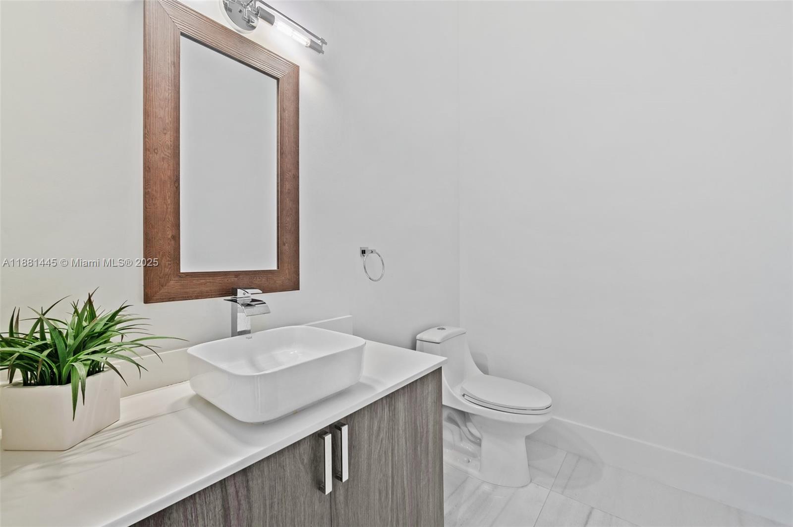 2400 Southwest 112th Avenue Davie, FL 33325 - Photo 23 of 61 a bathroom with a sink a toilet and a mirror