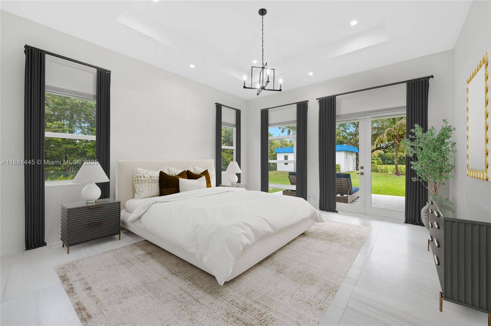 2400 Southwest 112th Avenue Davie, FL 33325 - Photo 24 of 61 a spacious bedroom with a balcony a bed and a chandelier