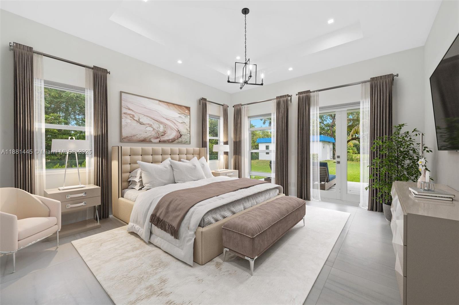 2400 Southwest 112th Avenue Davie, FL 33325 - Photo 25 of 61 a spacious bedroom with a large bed and a chandelier