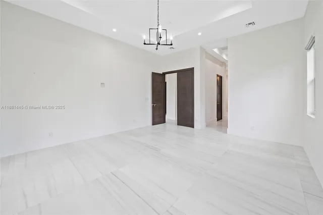 a spacious bathroom with a granite countertop sink mirror and shower