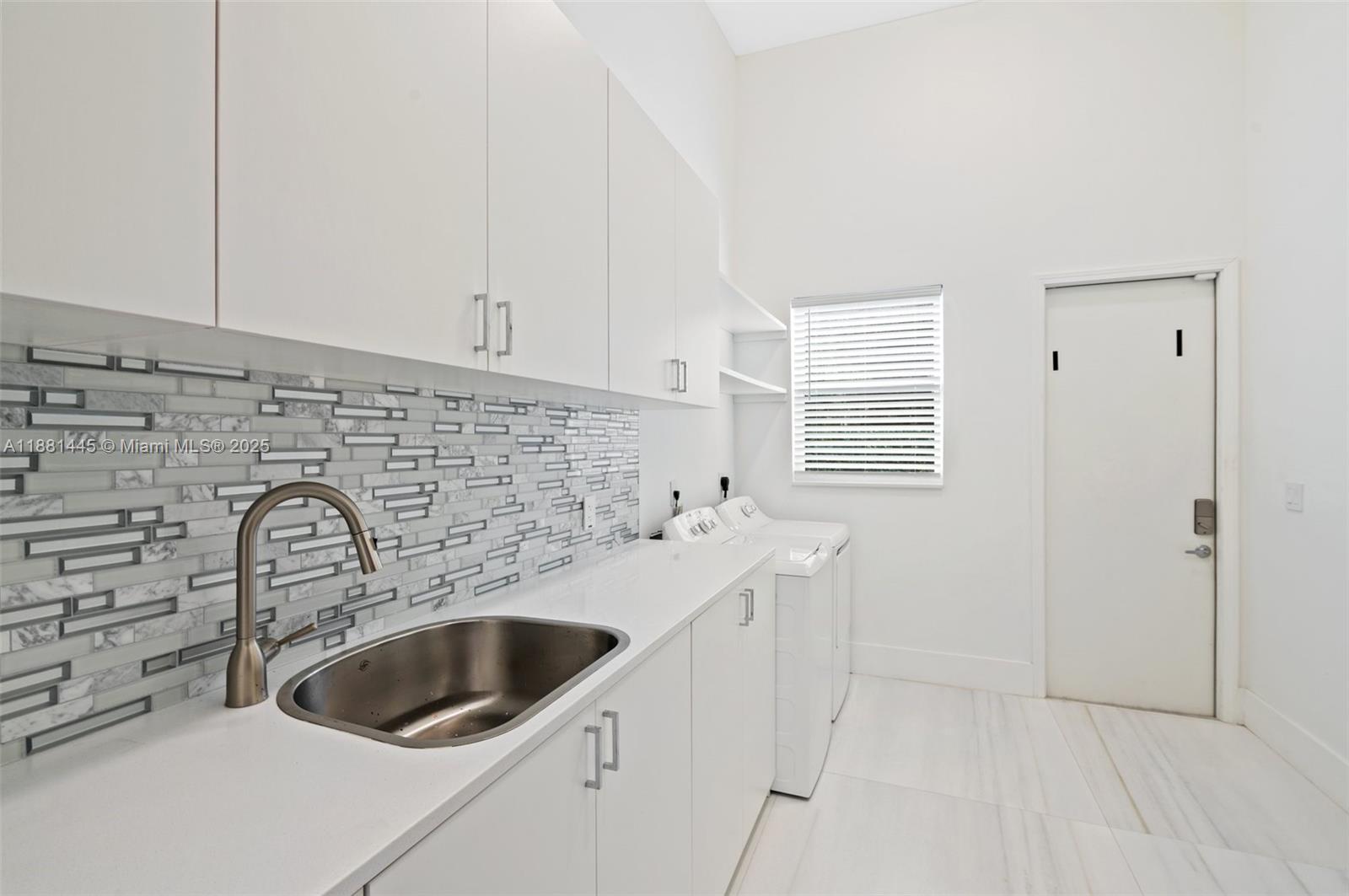 2400 Southwest 112th Avenue Davie, FL 33325 - Photo 42 of 61 a kitchen with a sink a stove and cabinets