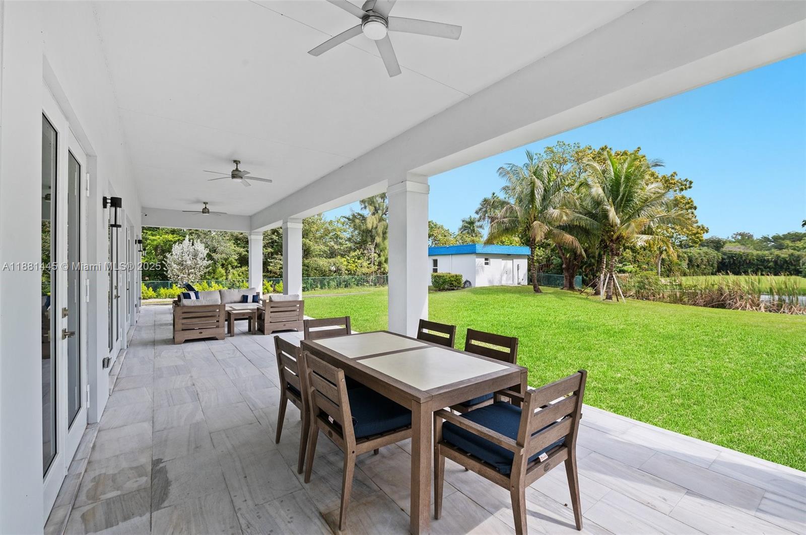 2400 Southwest 112th Avenue Davie, FL 33325 - Photo 46 of 61 a view of a patio with a table chairs and a backyard