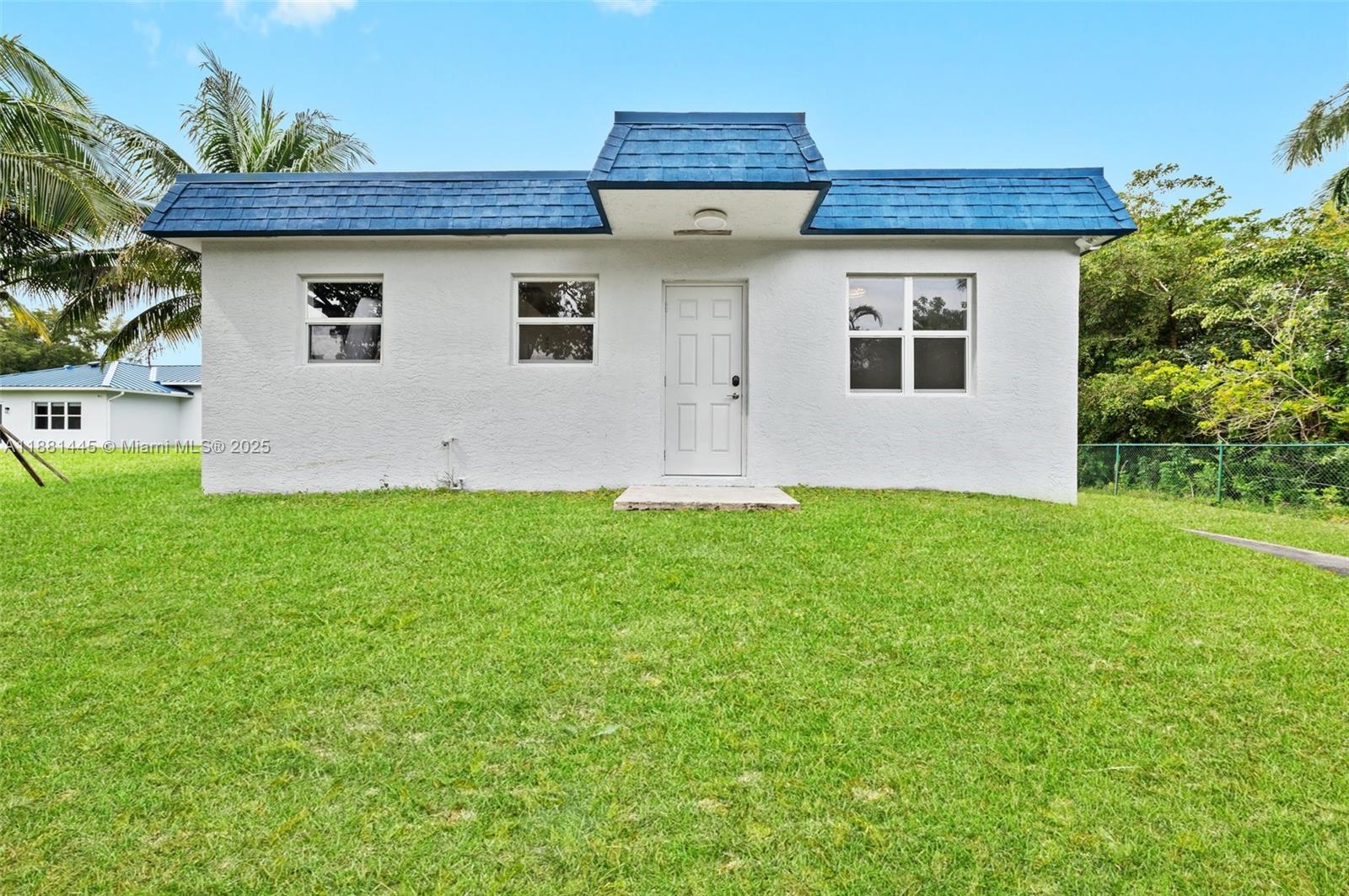 2400 Southwest 112th Avenue Davie, FL 33325 - Photo 53 of 61 a front view of a house with a yard and a garage