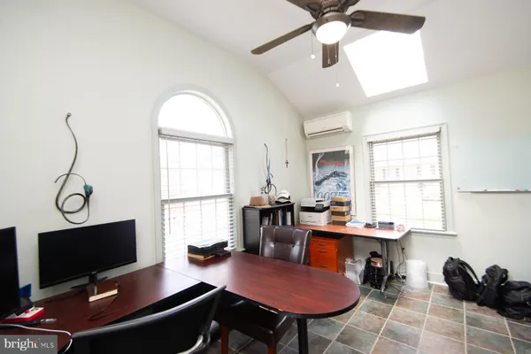 a workspace with furniture and a flat screen tv