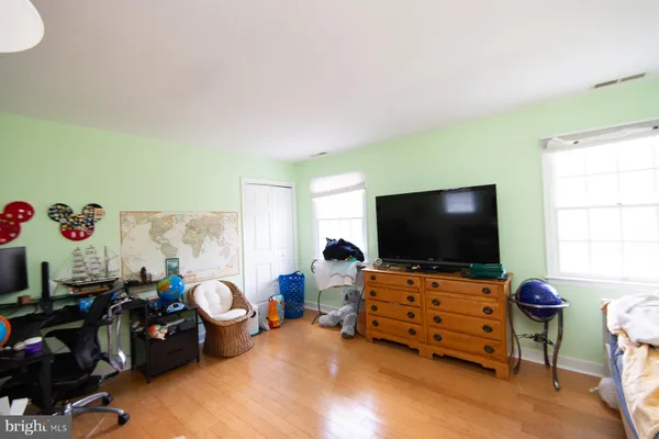 a bedroom with furniture and a flat screen tv