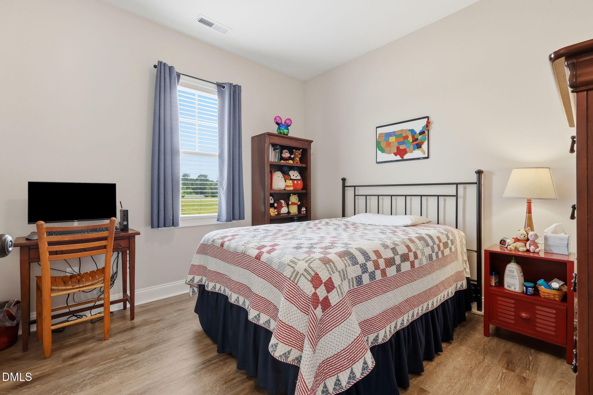 5098 Spring Hill Church Road Lillington, NC 27546 - Photo 21 of 36 a bedroom with a bed and a flat screen tv