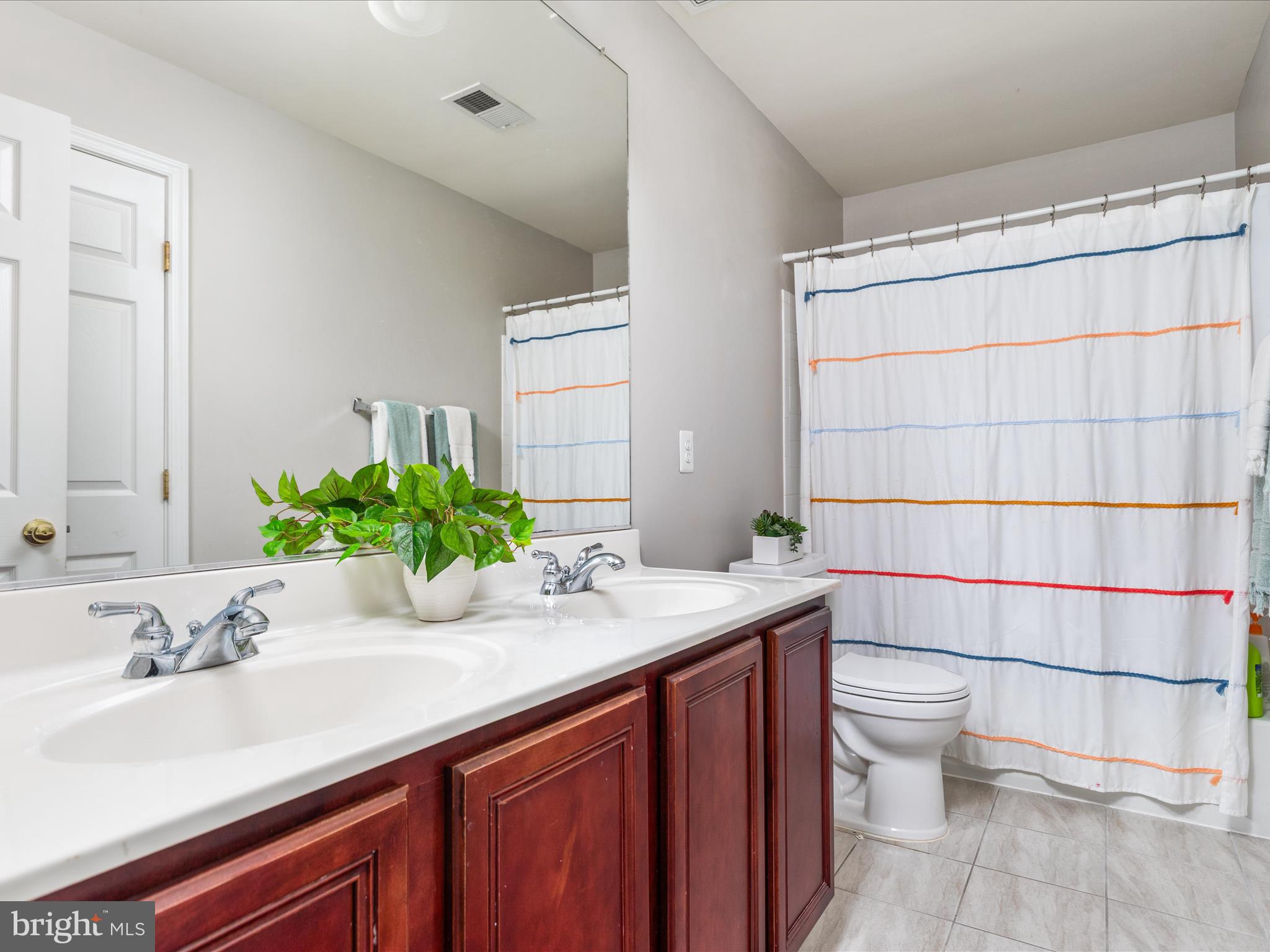 8705 Lords View Loop Gainesville, VA 20155 - Photo 26 of 58 a bathroom with a sink a toilet and shower