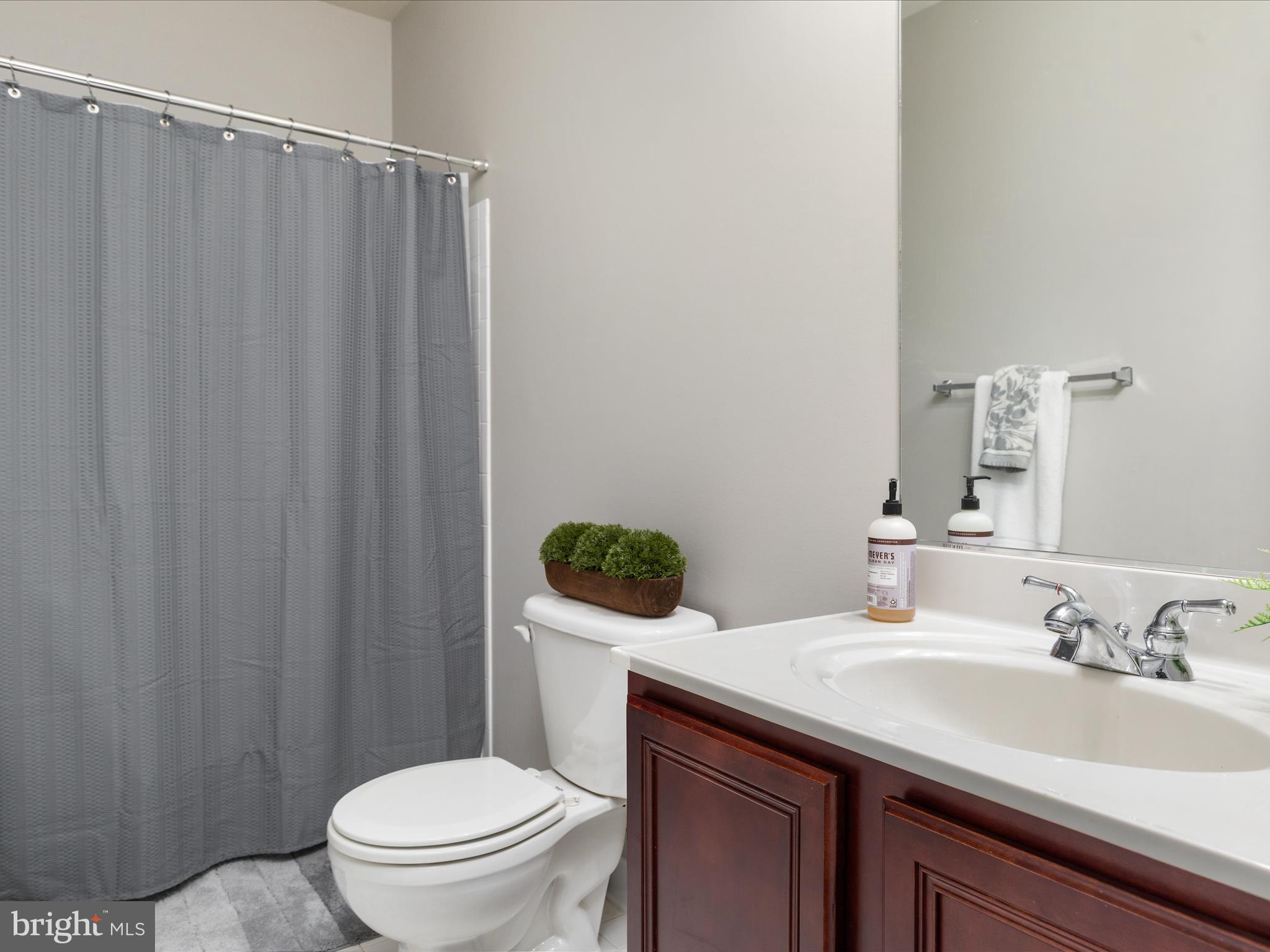 8705 Lords View Loop Gainesville, VA 20155 - Photo 34 of 58 a bathroom with a granite countertop sink toilet and a mirror