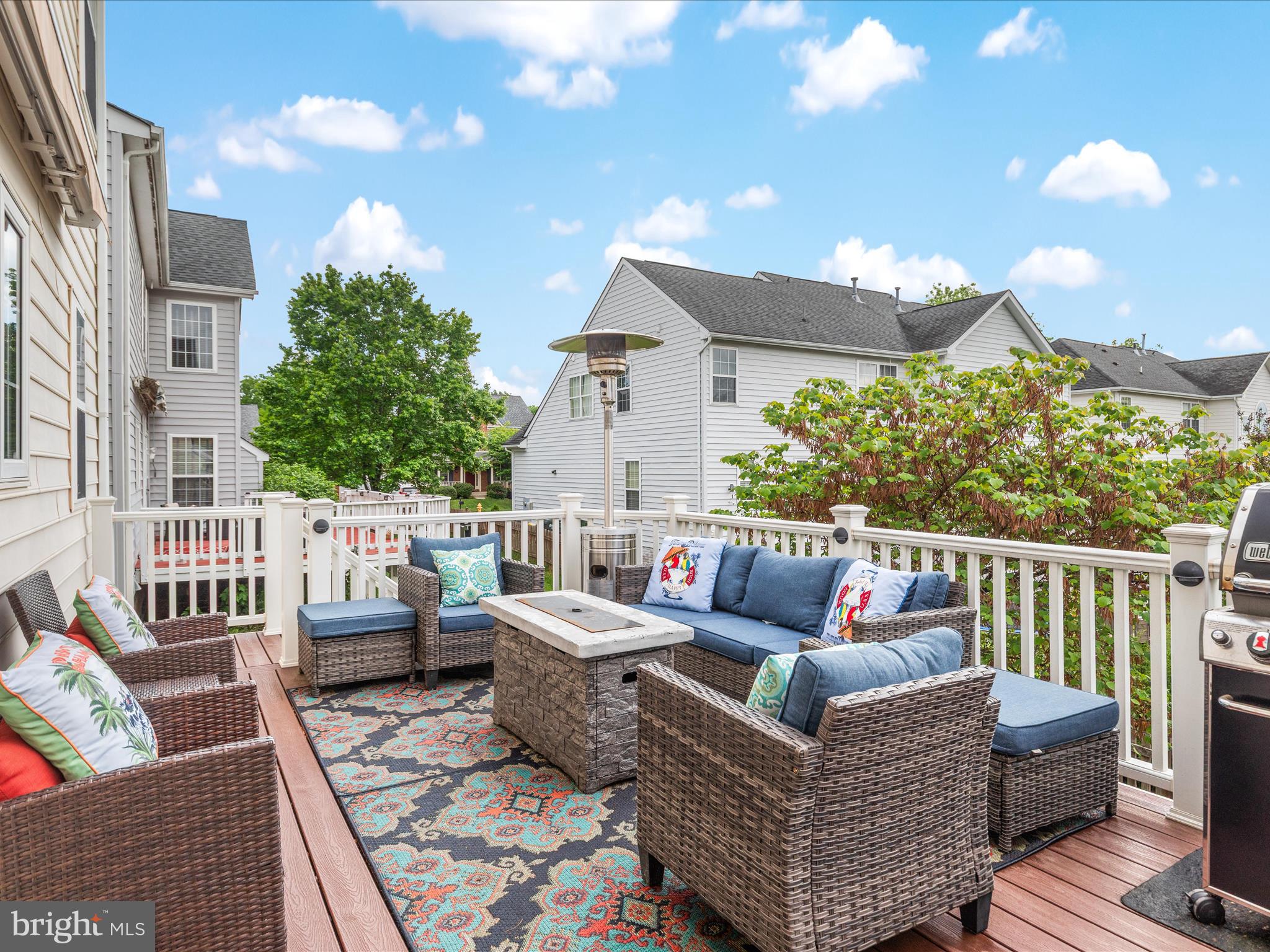 8705 Lords View Loop Gainesville, VA 20155 - Photo 36 of 58 a view of a patio with couches chairs potted plants and wooden floor
