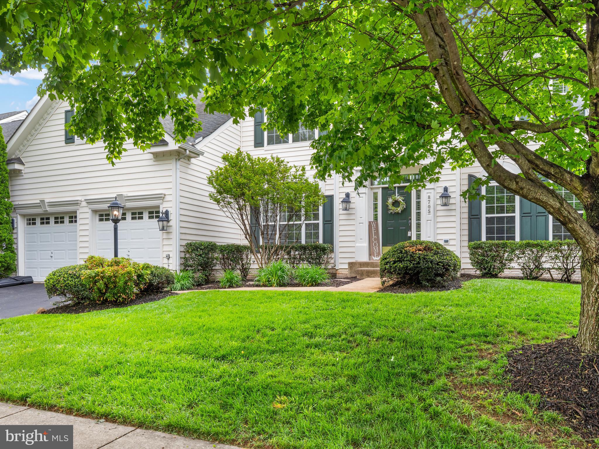 8705 Lords View Loop Gainesville, VA 20155 - Photo 38 of 58 a front view of a house with a yard and garage