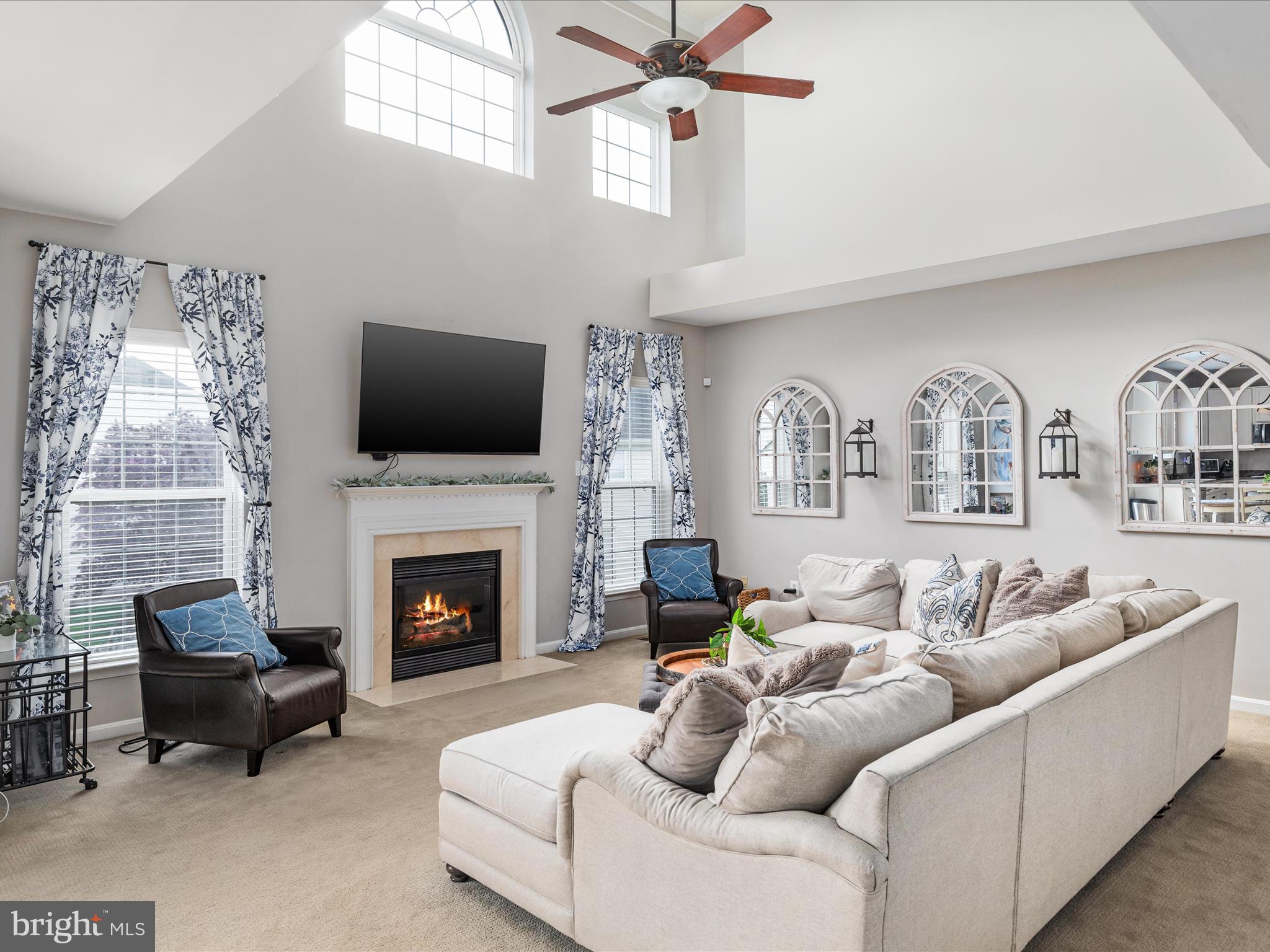 8705 Lords View Loop Gainesville, VA 20155 - Photo 7 of 58 a living room with furniture a fireplace and a flat screen tv