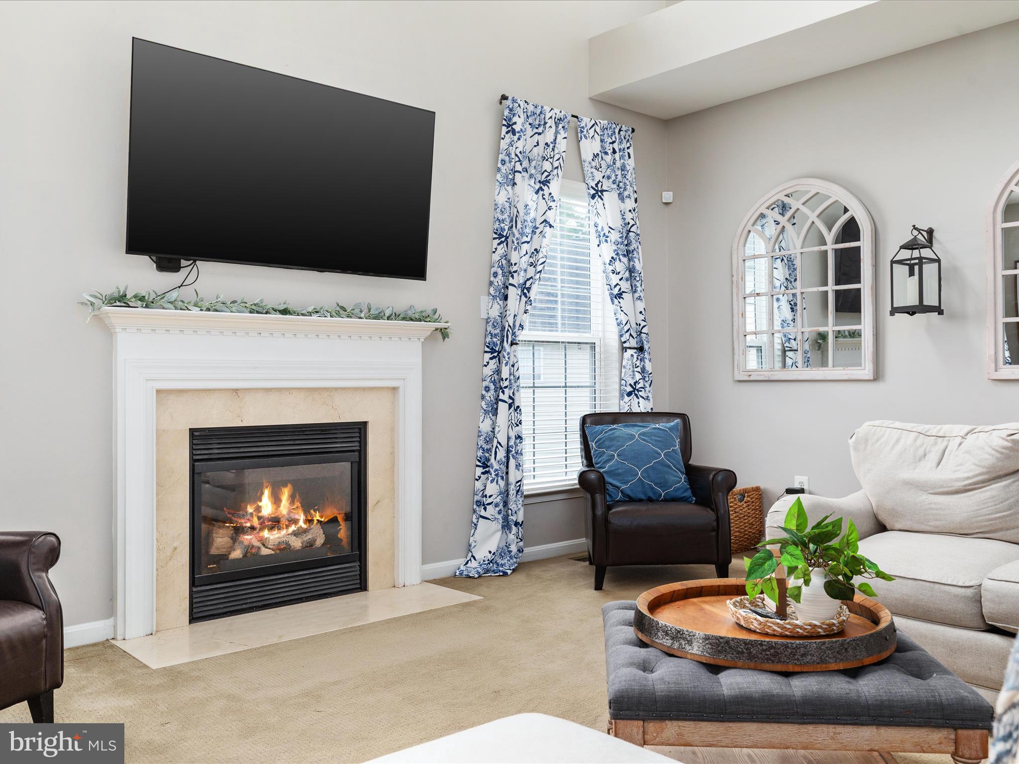 8705 Lords View Loop Gainesville, VA 20155 - Photo 8 of 58 a living room with furniture a fireplace and a flat screen tv