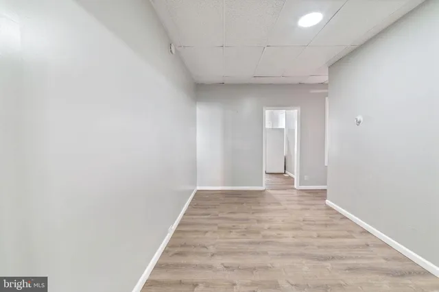 a view of an empty room and wooden floor