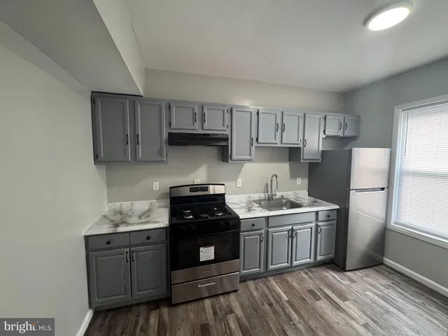 a kitchen with a stove a sink and a refrigerator