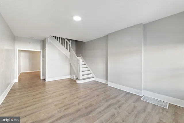 a view of an empty room with wooden floor
