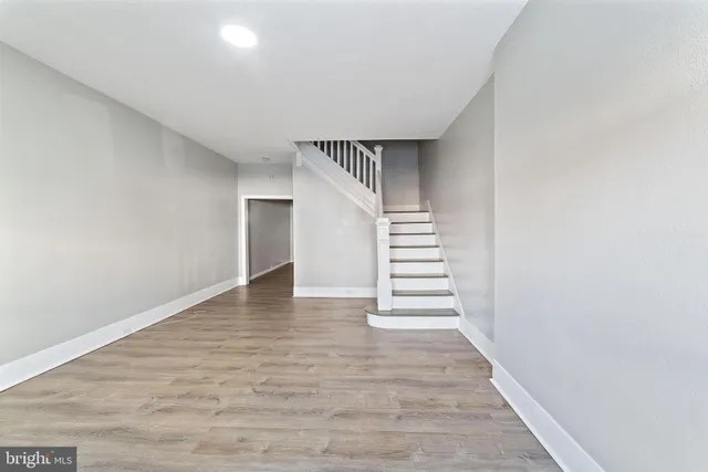 a view of entryway and hall with wooden floor