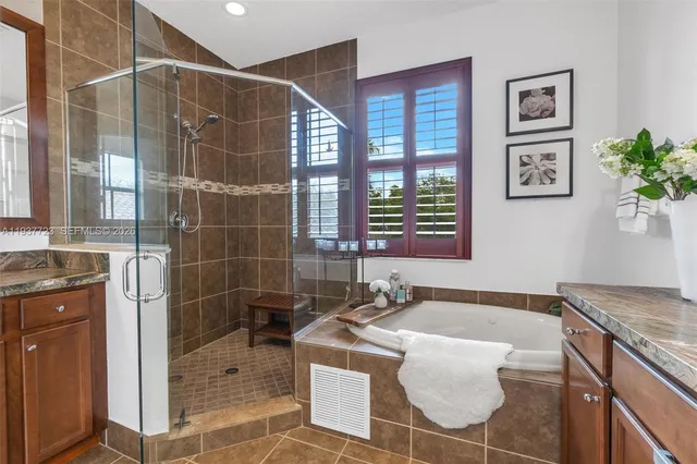 a bathroom with a granite countertop sink a toilet and a shower