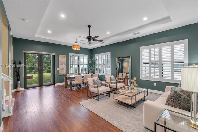 a living room with furniture and large windows