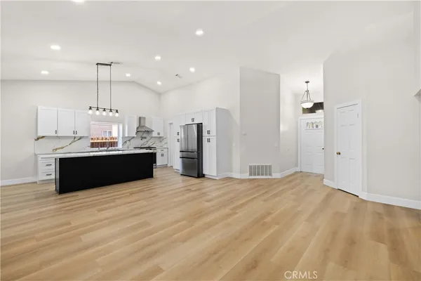 a kitchen with kitchen island a sink stainless steel appliances and cabinets