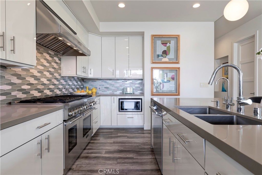 48 57th Place Long Beach, CA 90803 - Photo 14 of 47 a kitchen with granite countertop a sink stainless steel appliances and cabinets