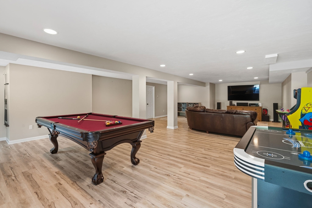 220 Newtown Road Acton, MA 01720 - Photo 24 of 39 a living room with furniture pool table and a wooden floor
