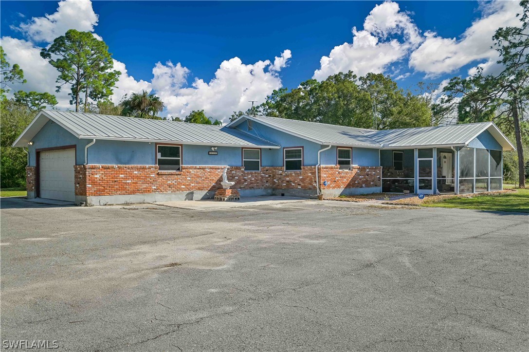20100 Haskins Road North Fort Myers, FL 33917 - Photo 1 of 35 a front view of a house with garden