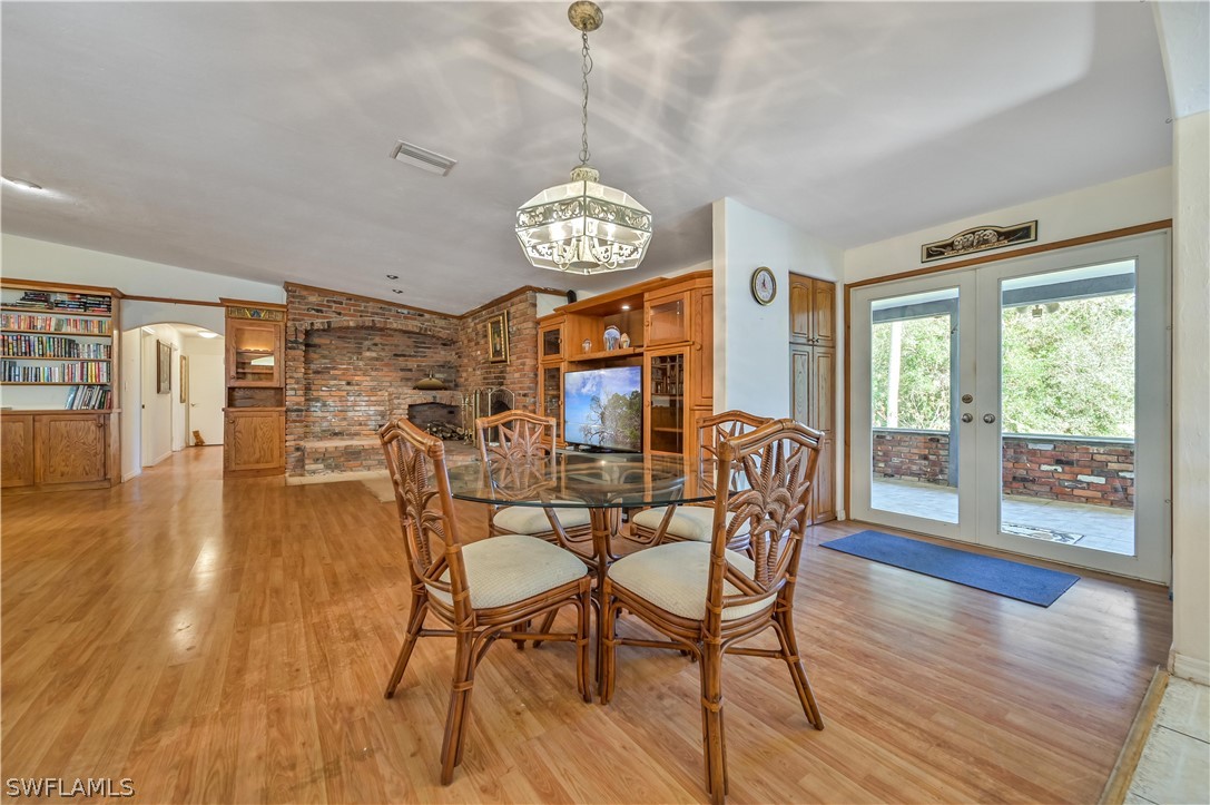 20100 Haskins Road North Fort Myers, FL 33917 - Photo 16 of 35 a view of a dining room with furniture window and wooden floor
