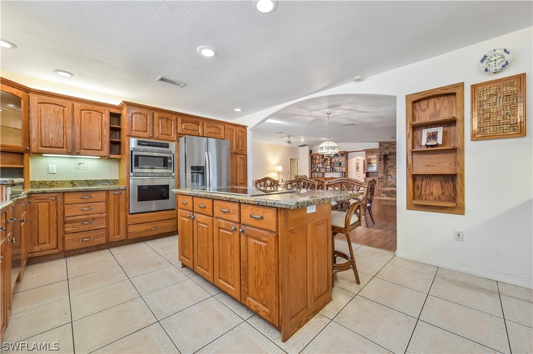 20100 Haskins Road North Fort Myers, FL 33917 - Photo 18 of 35 a kitchen with stainless steel appliances a sink counter space and a view of kitchen