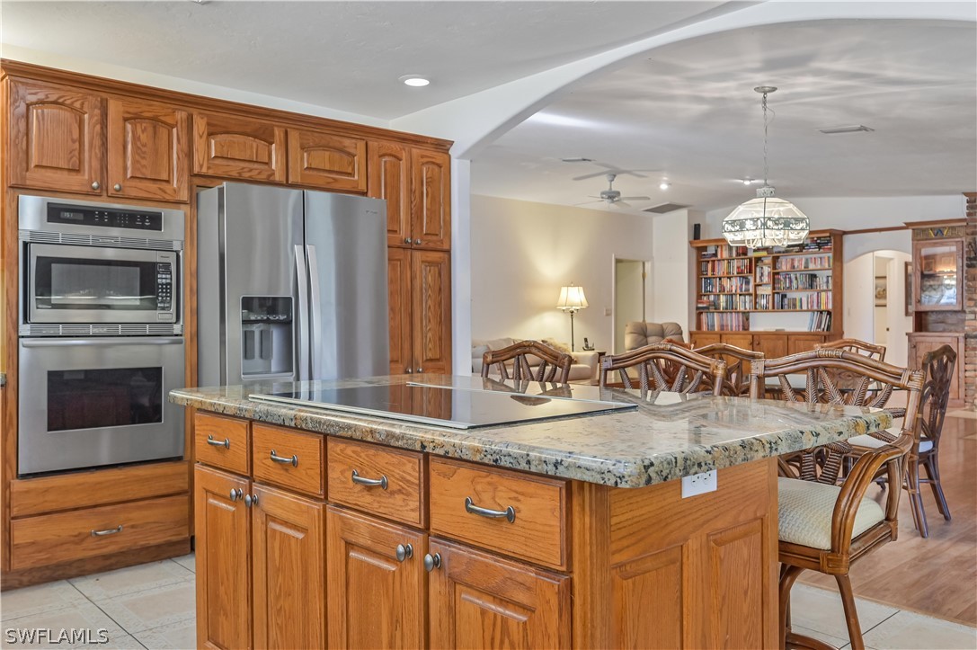 20100 Haskins Road North Fort Myers, FL 33917 - Photo 19 of 35 a kitchen with stainless steel appliances granite countertop a stove a sink and a refrigerator