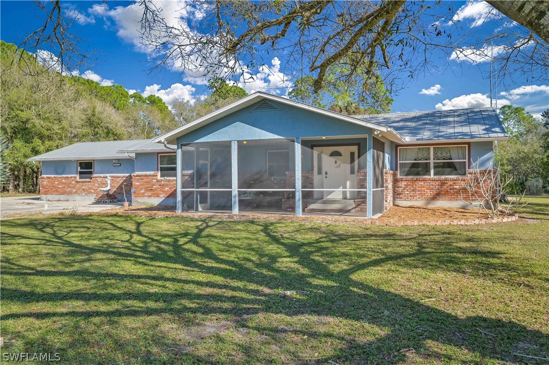 20100 Haskins Road North Fort Myers, FL 33917 - Photo 2 of 35 a front view of a house with a garden