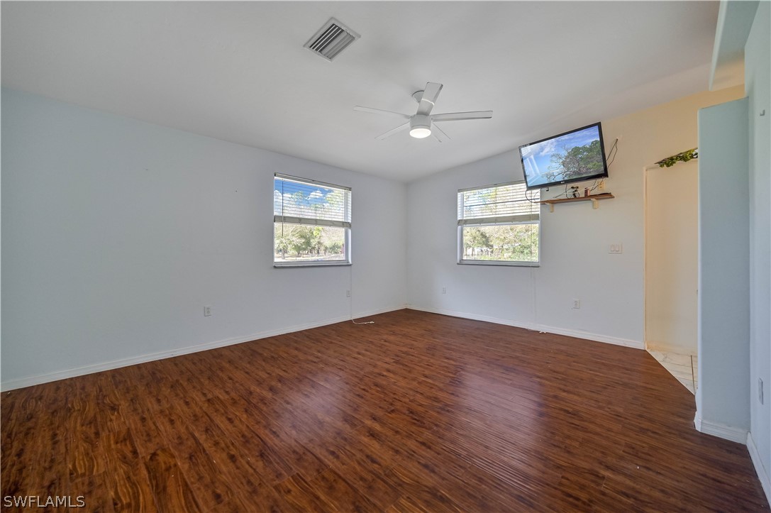 20100 Haskins Road North Fort Myers, FL 33917 - Photo 22 of 35 wooden floor in an empty room with a window
