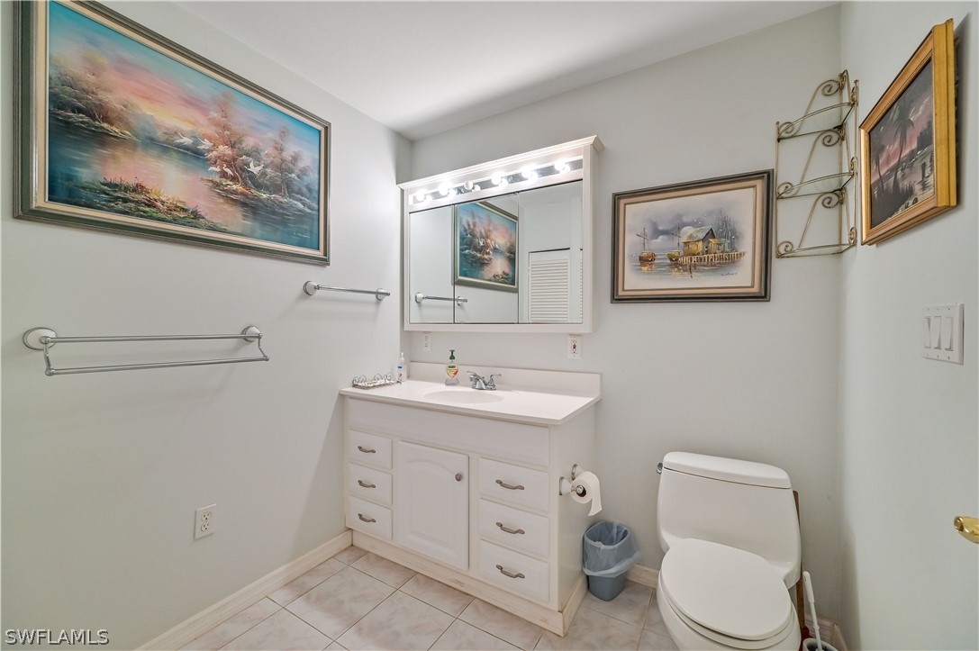 20100 Haskins Road North Fort Myers, FL 33917 - Photo 28 of 35 a bathroom with a toilet a sink and mirror
