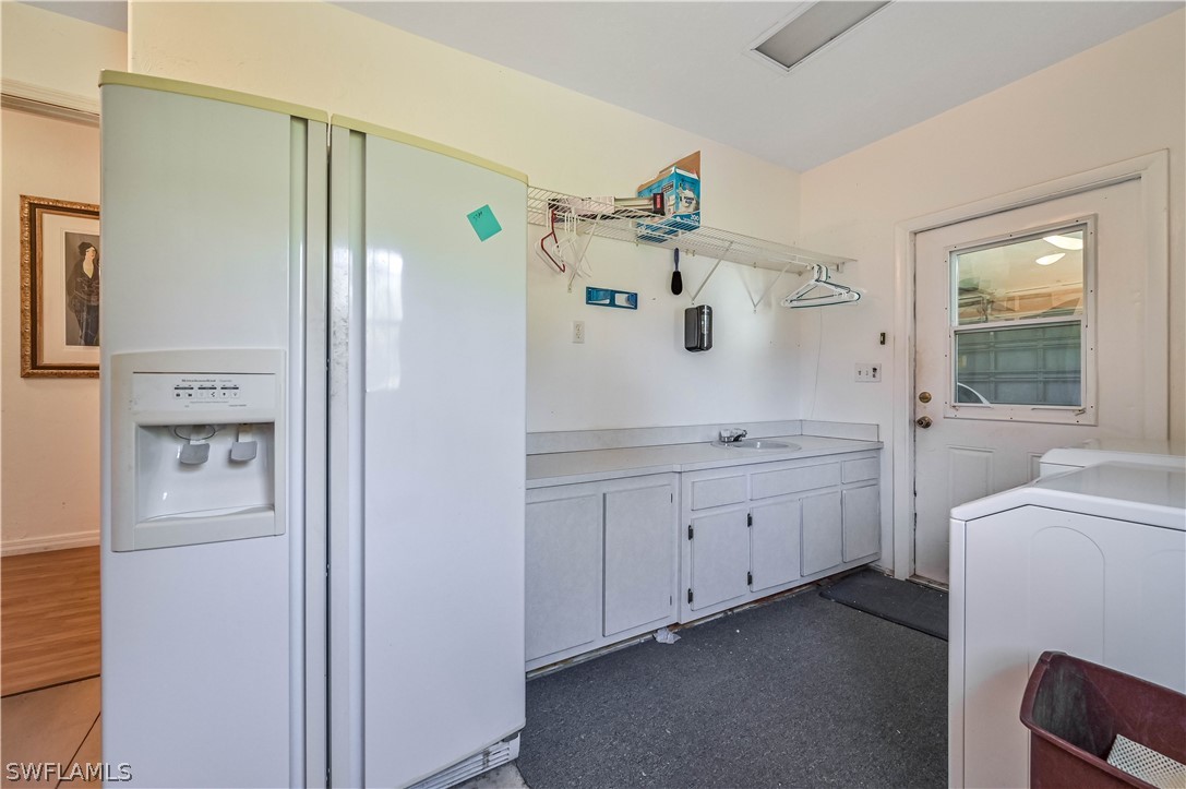 20100 Haskins Road North Fort Myers, FL 33917 - Photo 31 of 35 a spacious bathroom with a double vanity sink a large mirror a shower and a bathtub