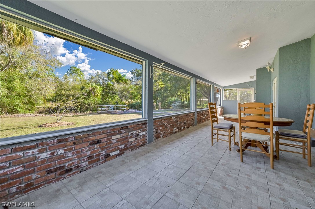 20100 Haskins Road North Fort Myers, FL 33917 - Photo 35 of 35 a living room with a large window and a table