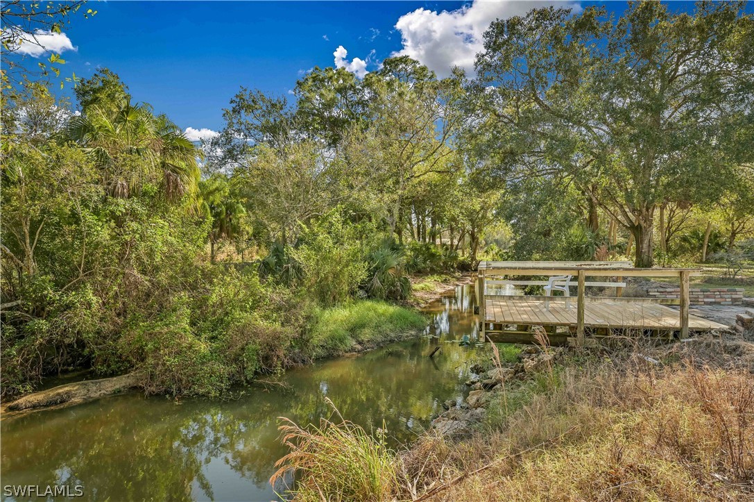 20100 Haskins Road North Fort Myers, FL 33917 - Photo 5 of 35 a backyard of a house with table and chairs