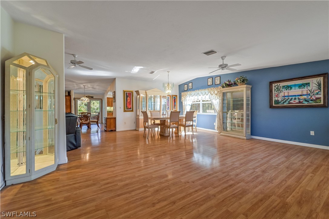 20100 Haskins Road North Fort Myers, FL 33917 - Photo 10 of 35 a view of a livingroom with furniture wooden floor and a flat screen tv