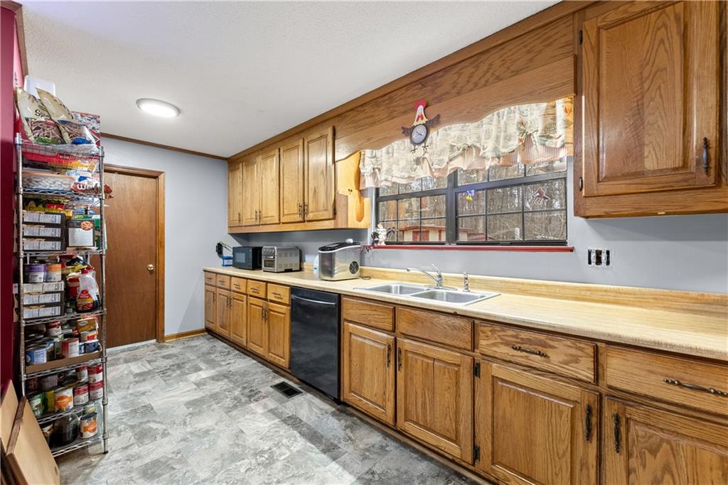 1527 Gold Mine Road Dawsonville, GA 30534 - Photo 13 of 39 a kitchen with stainless steel appliances granite countertop a sink and cabinets