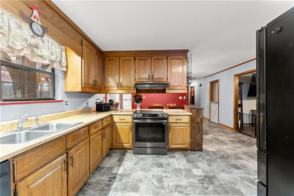1527 Gold Mine Road Dawsonville, GA 30534 - Photo 14 of 39 a kitchen with stainless steel appliances granite countertop a stove a sink and a refrigerator