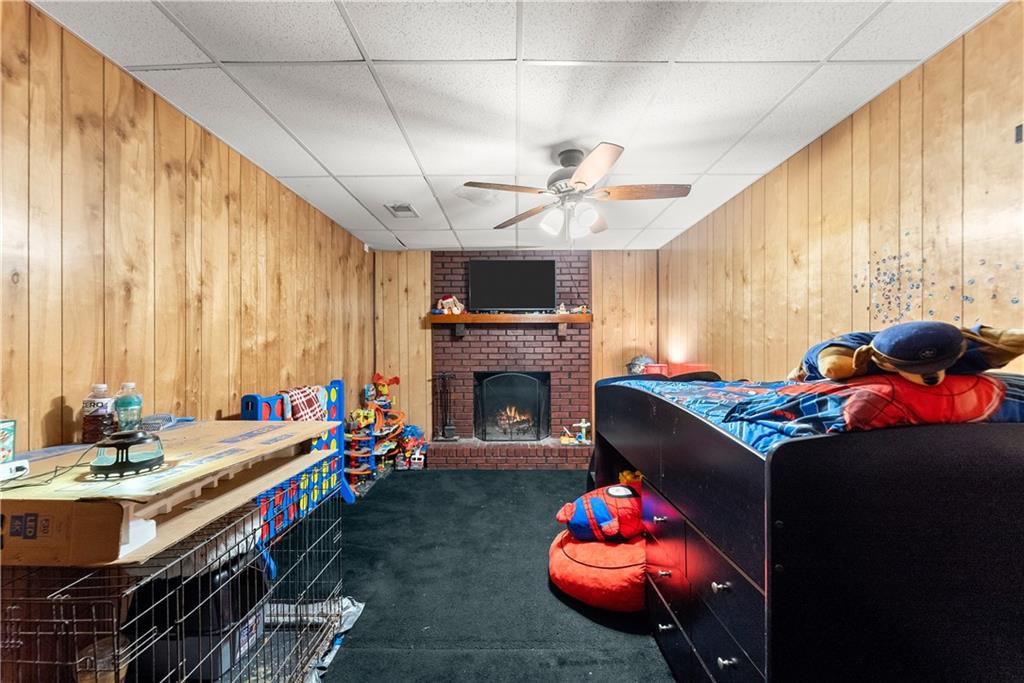 1527 Gold Mine Road Dawsonville, GA 30534 - Photo 16 of 39 a living room with furniture a fireplace and a chandelier