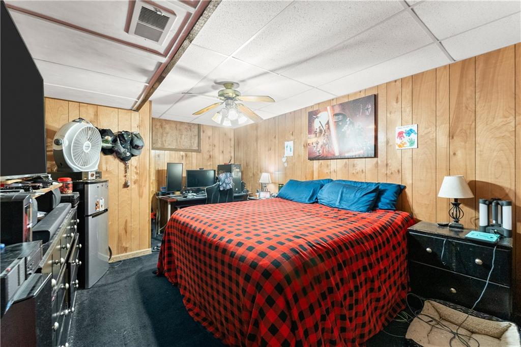 1527 Gold Mine Road Dawsonville, GA 30534 - Photo 17 of 39 a bedroom with a bed and a chandelier