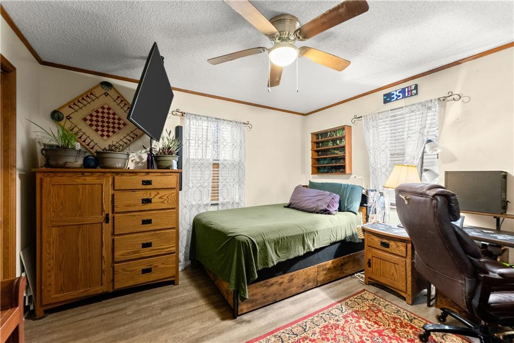 1527 Gold Mine Road Dawsonville, GA 30534 - Photo 20 of 39 a bedroom with a bed and wooden floor